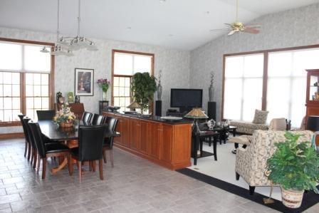 Den/Family/Great Room. Great Room has 3 walls of windows and is open to the kitchen and dining room.  Also has built-in cabinetry