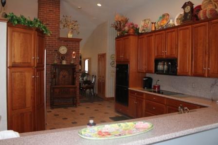 Kitchen. The Kitchen features courian countertops and ceremic tile floors.  The ovens are electric made by Thermodore and one is a convection oven.  The refrigerator is a Sub-Zero double door with custom Cherry Door Panels.