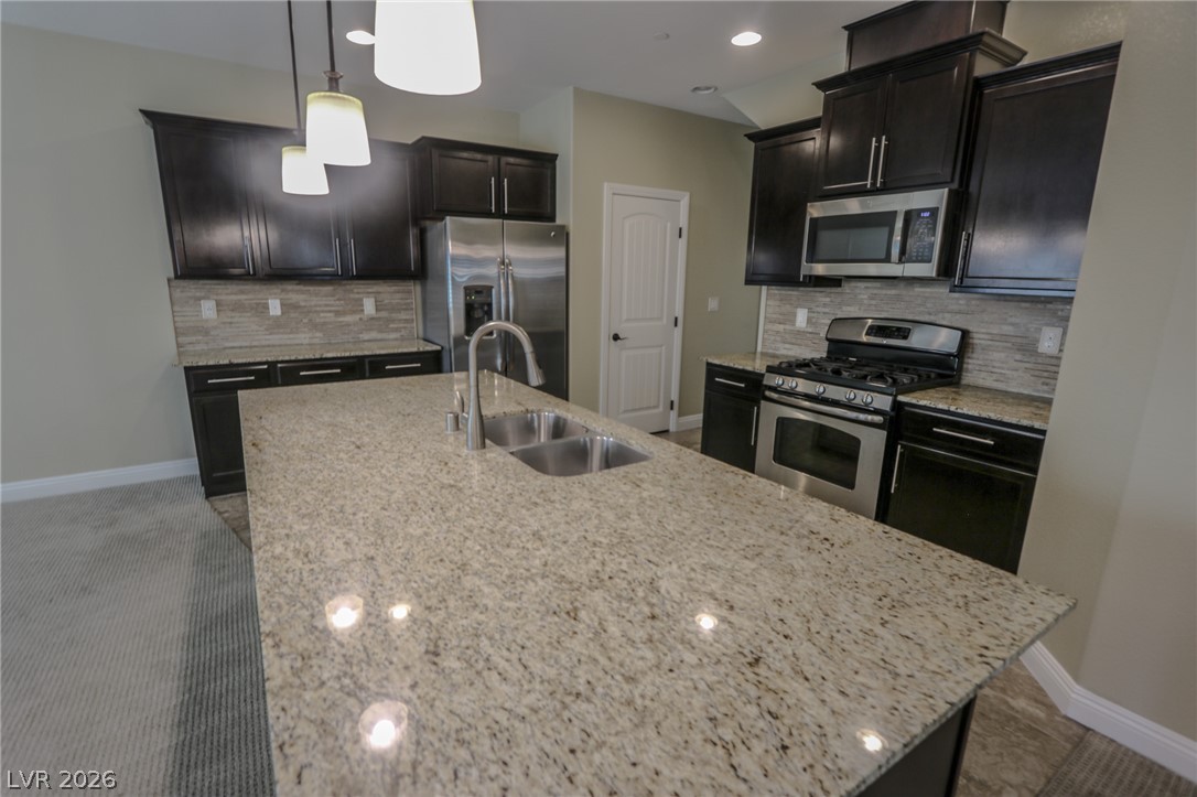 Rich dark cabinetry and a prominent granite island establish a modern focal point.