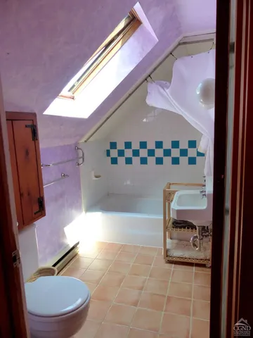 a bathroom with a bathtub and toilet