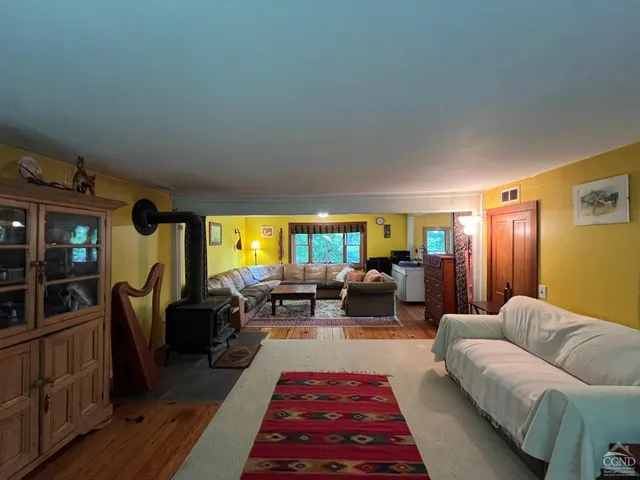 a living room with furniture fireplace and window