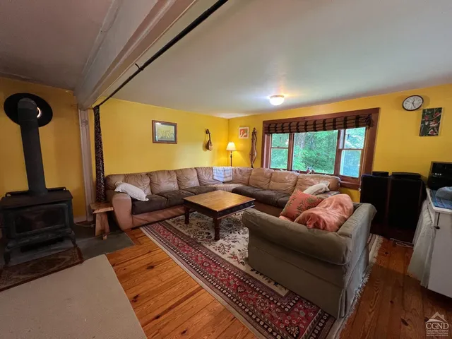 a living room with furniture a rug and a large window