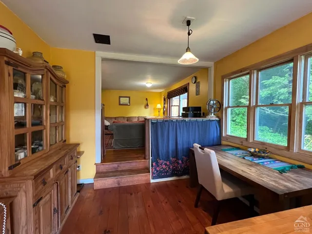 a view of a livingroom with furniture window and wooden floor