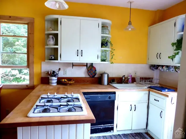 a kitchen with a stove a sink and a microwave