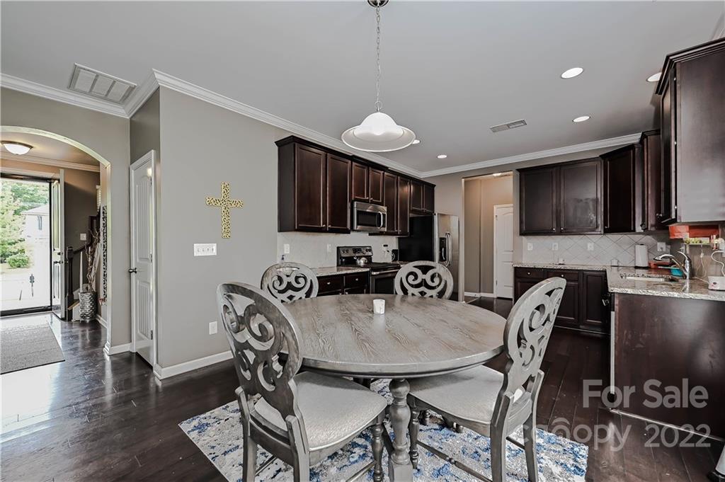 10311 Atkins Ridge Drive Charlotte, NC 28213 - Photo 6 of 18 a view of a dining room with furniture a kitchen and chandelier