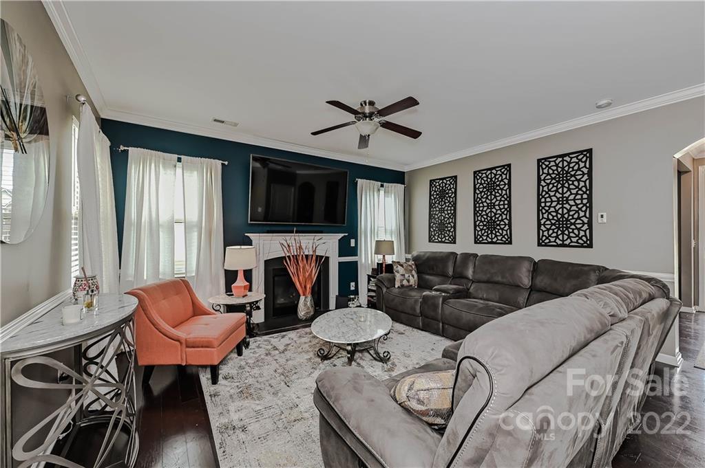 10311 Atkins Ridge Drive Charlotte, NC 28213 - Photo 8 of 18 a living room with furniture a flat screen tv and a large window