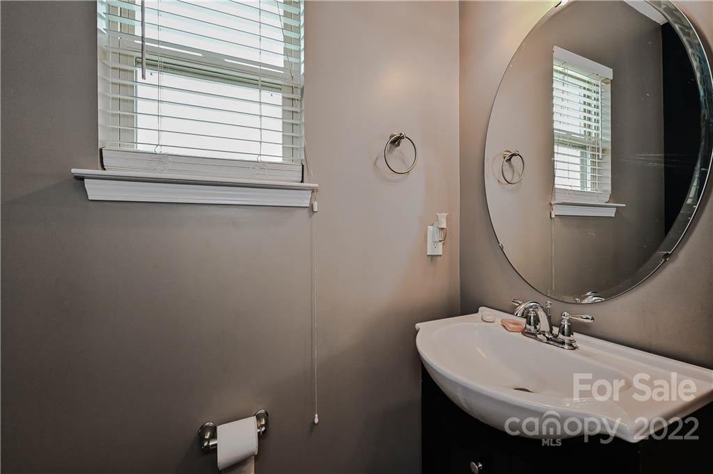 10311 Atkins Ridge Drive Charlotte, NC 28213 - Photo 9 of 18 a bathroom with a sink and a mirror