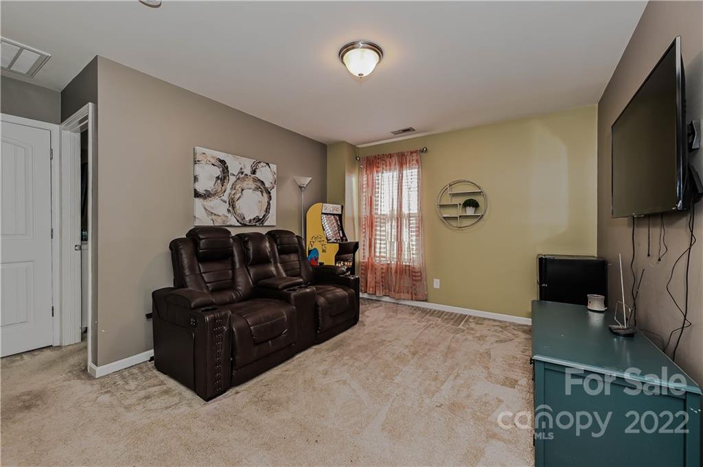 10311 Atkins Ridge Drive Charlotte, NC 28213 - Photo 10 of 18 a living room with furniture and a flat screen tv