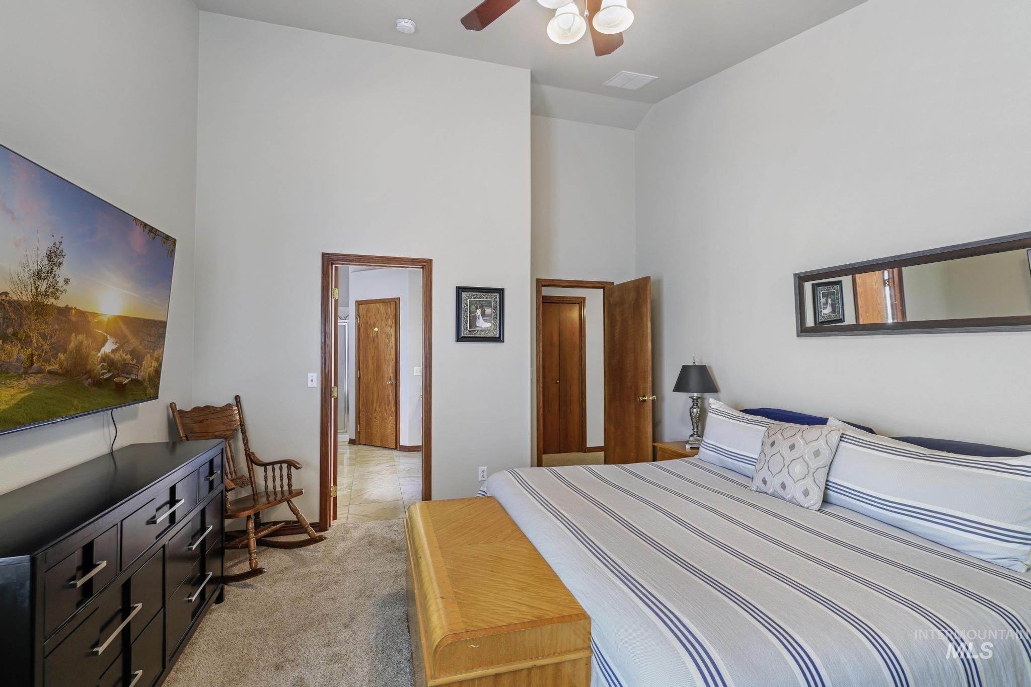 1558 Brookside Loop Twin Falls, ID 83301 - Photo 19 of 47 Carpeted room with a vaulted ceiling, ceiling fan, and wood-trim doors