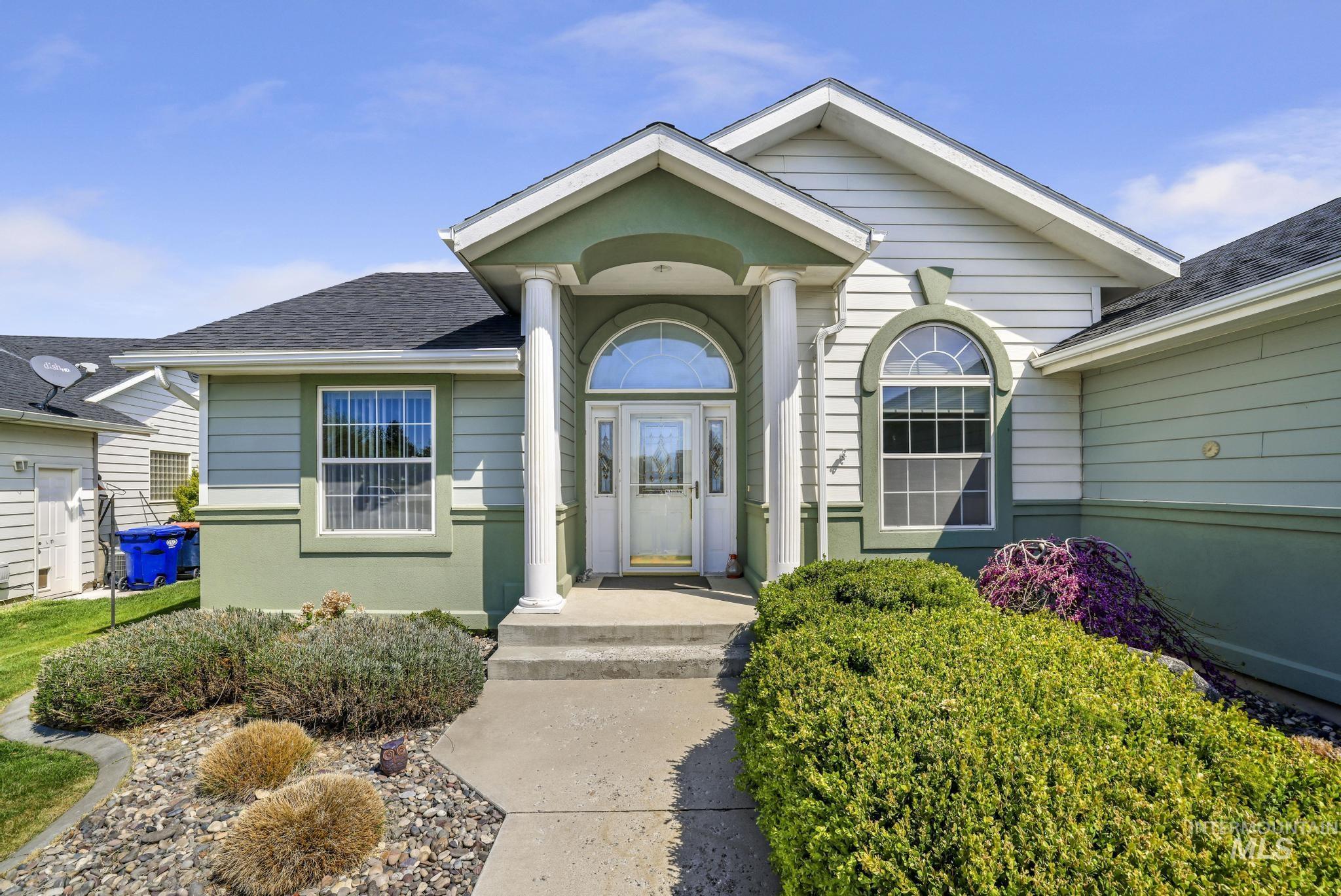 1558 Brookside Loop Twin Falls, ID 83301 - Photo 28 of 47 Front elevation featuring a covered entryway with a half-round transom window, two decorative columns, and a concrete pathway