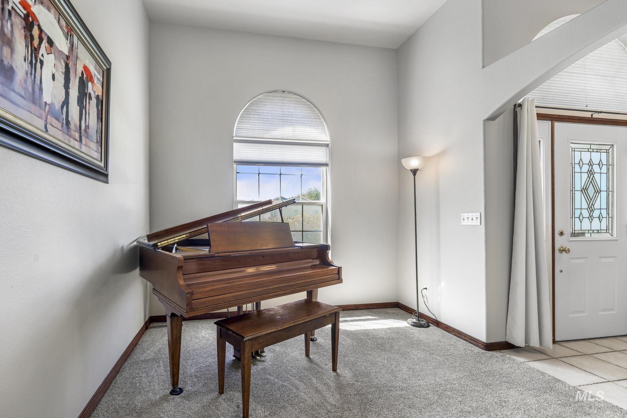 1558 Brookside Loop Twin Falls, ID 83301 - Photo 5 of 47 Arched window with blinds, light gray wall paint, dark wood baseboards, and a white front door with decorative glass inserts