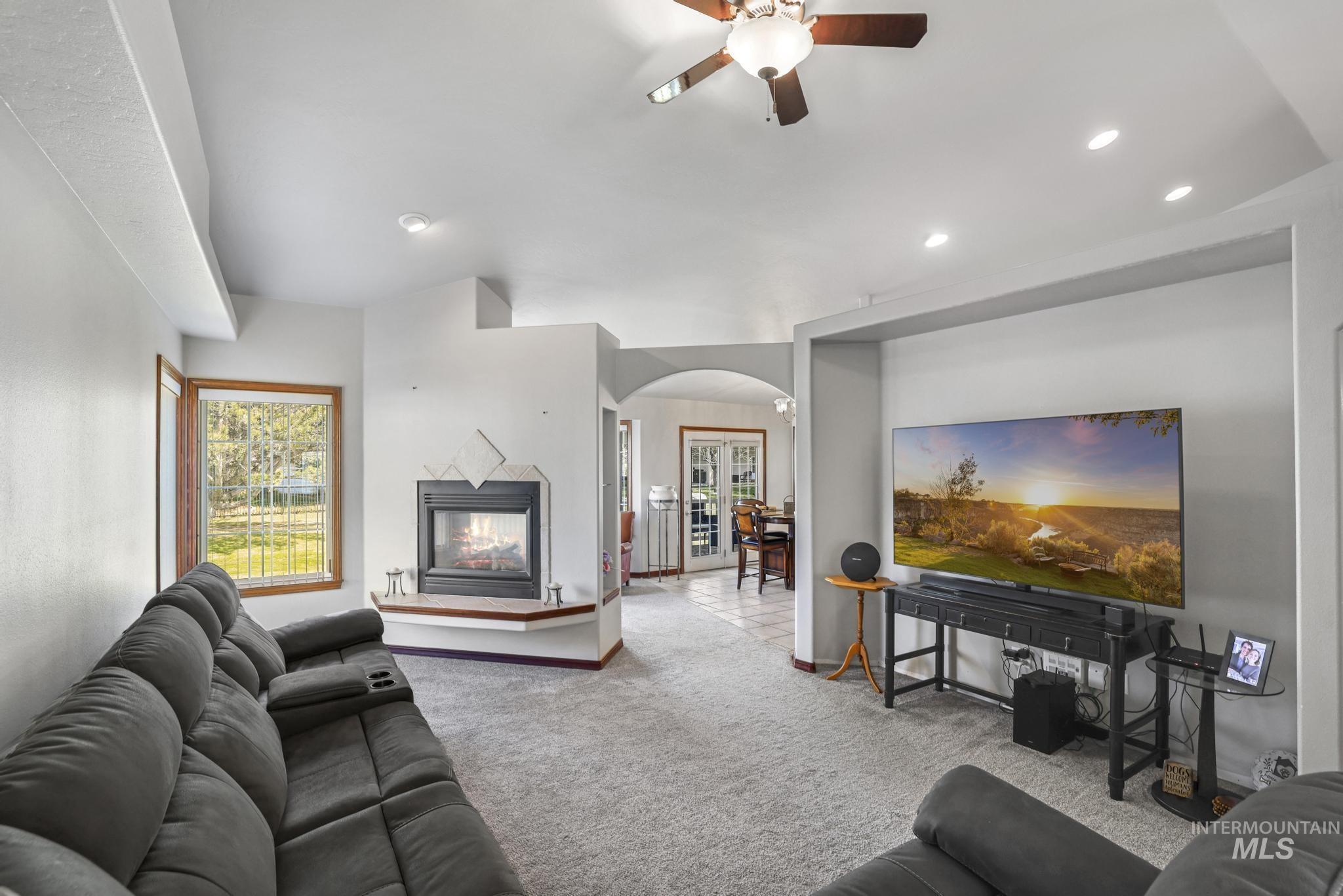 1558 Brookside Loop Twin Falls, ID 83301 - Photo 7 of 47 Carpeted living space featuring a tiled fireplace with hearth, recessed lighting, and a ceiling fan