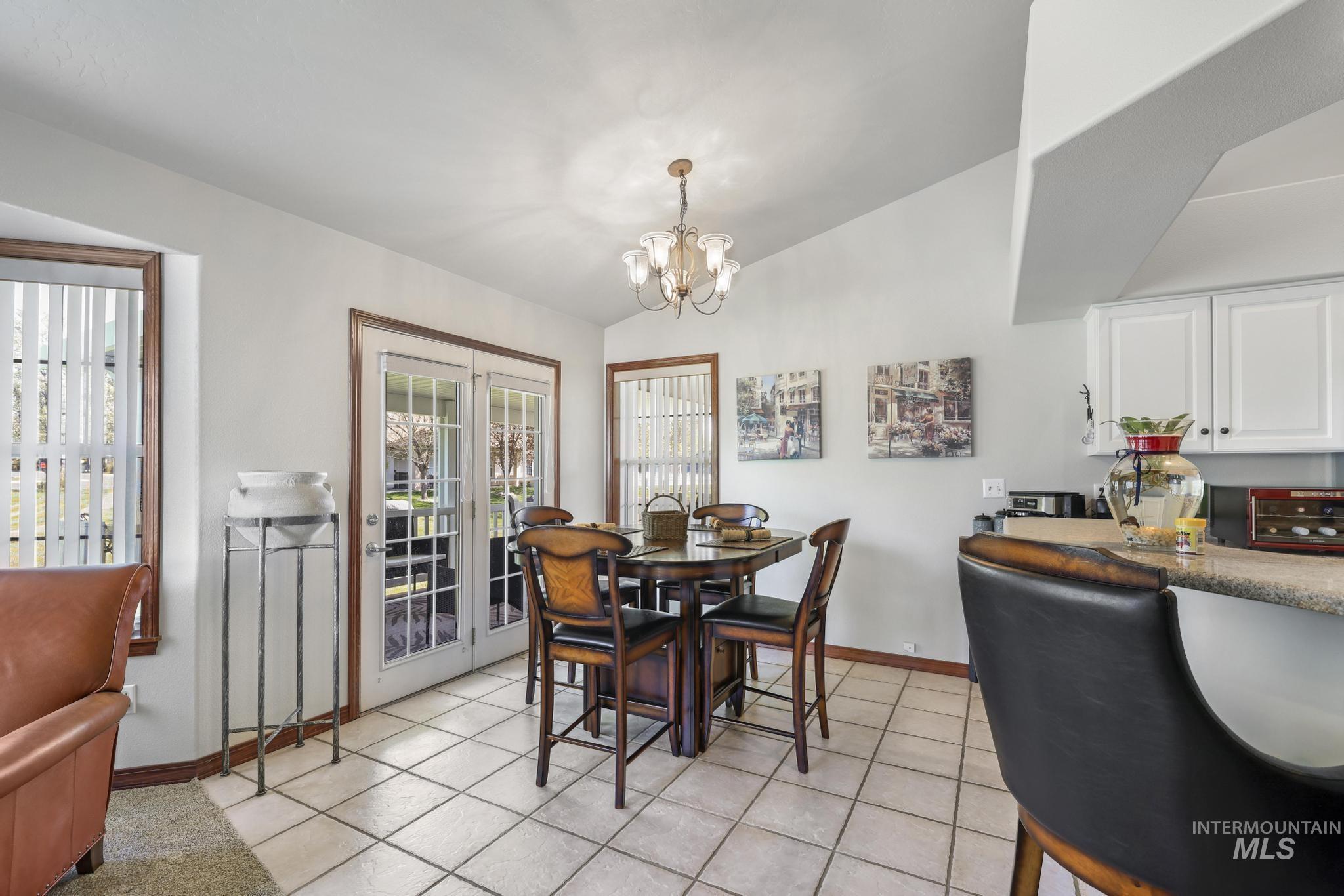 1558 Brookside Loop Twin Falls, ID 83301 - Photo 9 of 47 Bright dining area featuring tile flooring, a chandelier fixture, and French doors