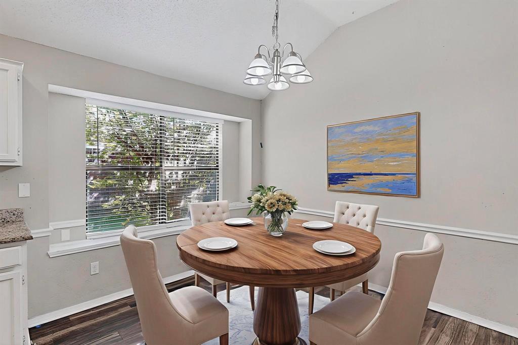 820 Charter Oak Street Allen, TX 75002 - Photo 13 of 37 Dining room featuring a chandelier, lofted ceiling, and dark wood-style floors