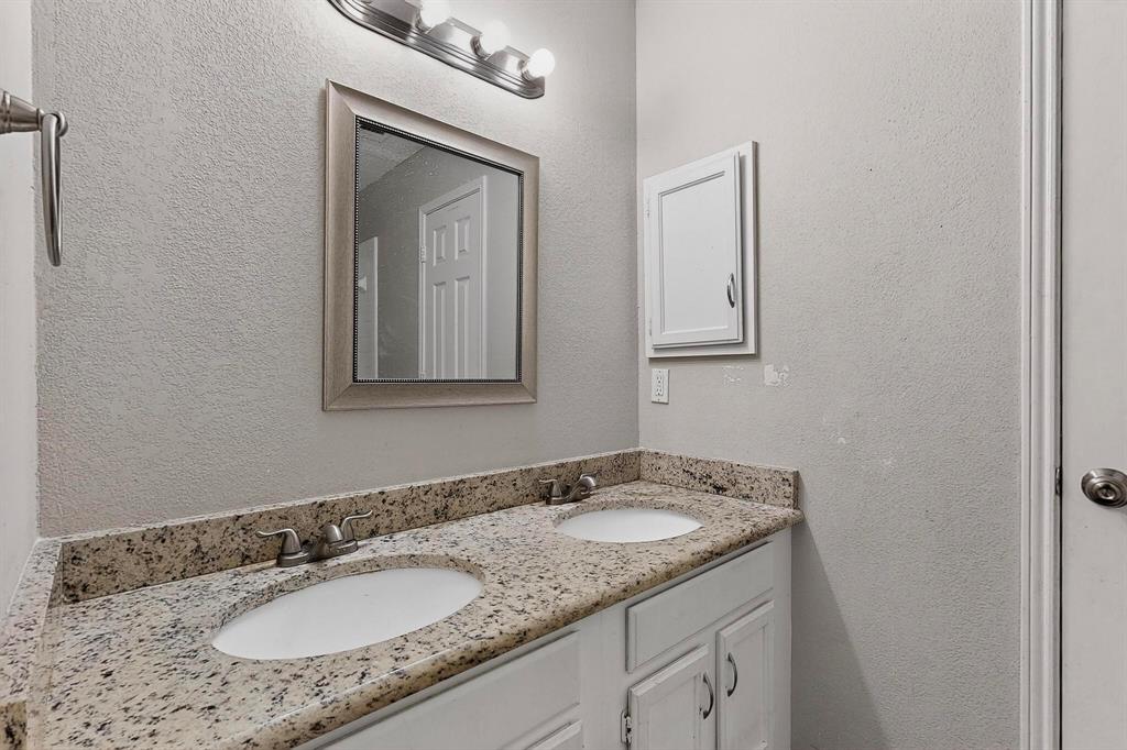 820 Charter Oak Street Allen, TX 75002 - Photo 21 of 37 Bathroom with a textured wall and double vanity