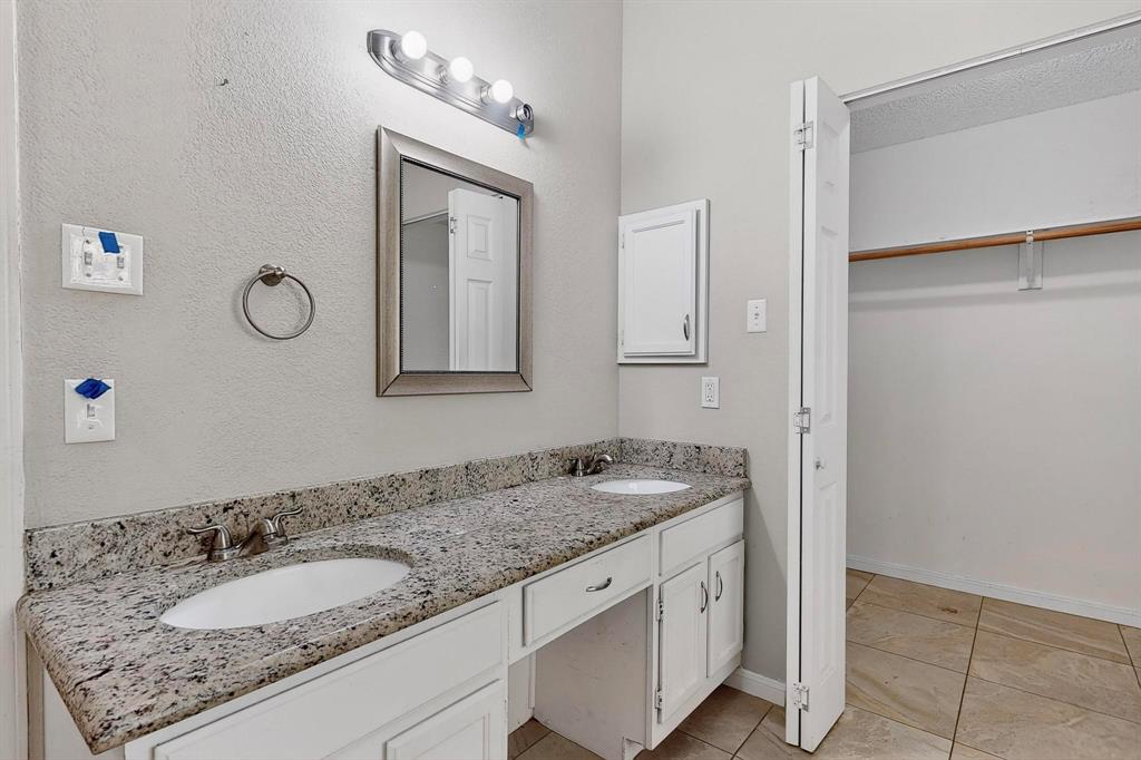 820 Charter Oak Street Allen, TX 75002 - Photo 24 of 37 Bathroom featuring double vanity, light tile patterned flooring, and a spacious closet
