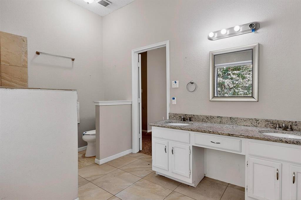 820 Charter Oak Street Allen, TX 75002 - Photo 25 of 37 Bathroom with double vanity and light tile patterned flooring