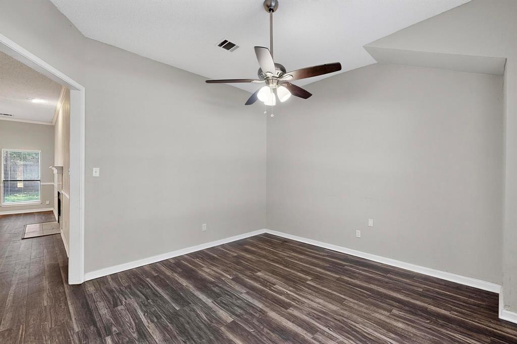 820 Charter Oak Street Allen, TX 75002 - Photo 28 of 37 Empty room with dark wood-style floors, ceiling fan, and lofted ceiling