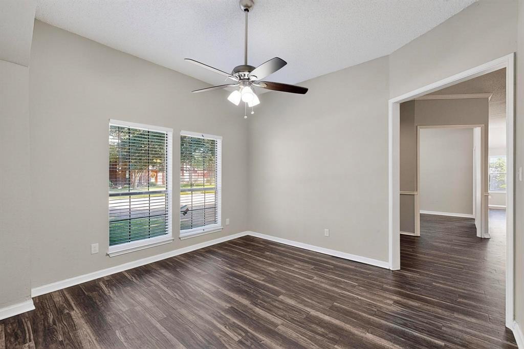 820 Charter Oak Street Allen, TX 75002 - Photo 29 of 37 Empty room featuring dark wood-type flooring, a textured ceiling, and a ceiling fan