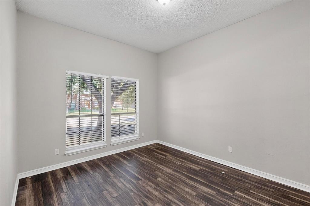 820 Charter Oak Street Allen, TX 75002 - Photo 30 of 37 Spare room featuring dark wood-style flooring and a textured ceiling