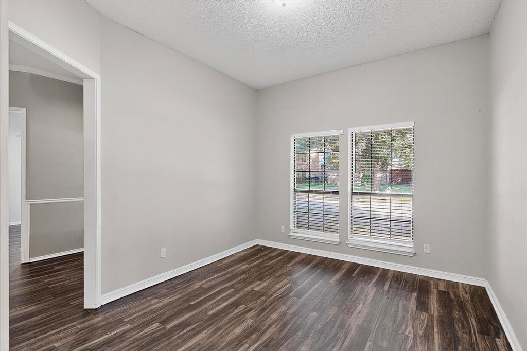 820 Charter Oak Street Allen, TX 75002 - Photo 31 of 37 Unfurnished room featuring a textured ceiling and dark wood-type flooring