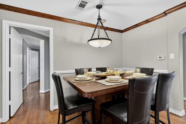 a view of a dining room with furniture wooden floor and chandelier
