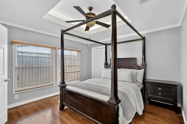 a bedroom with a bed and a ceiling fan