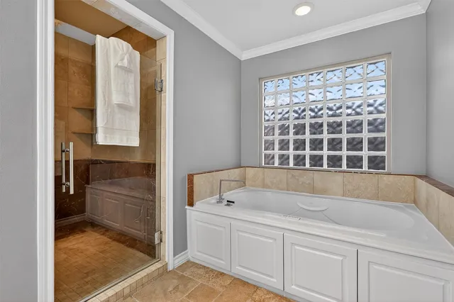 a bathroom with a tub sink and mirror