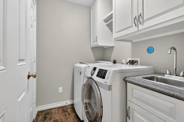 a view of an empty room with wooden floor and a mirror