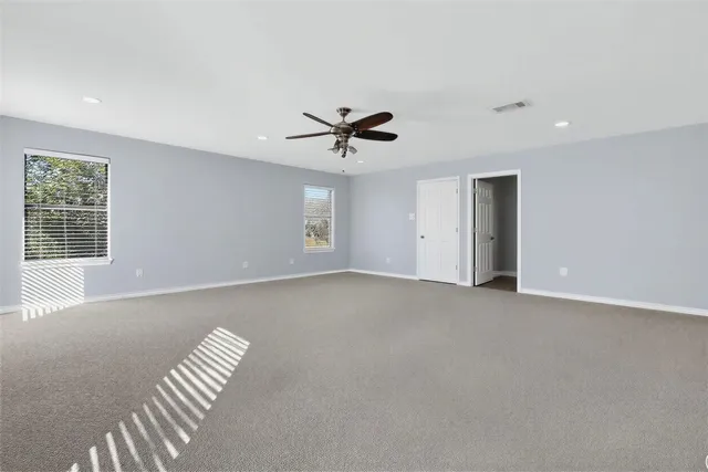 a living room with furniture a ceiling fan and a window