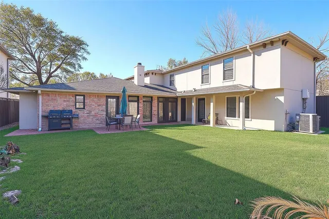 a view of a house with a yard and sitting area