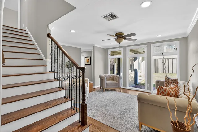 a living room with furniture and wooden floor