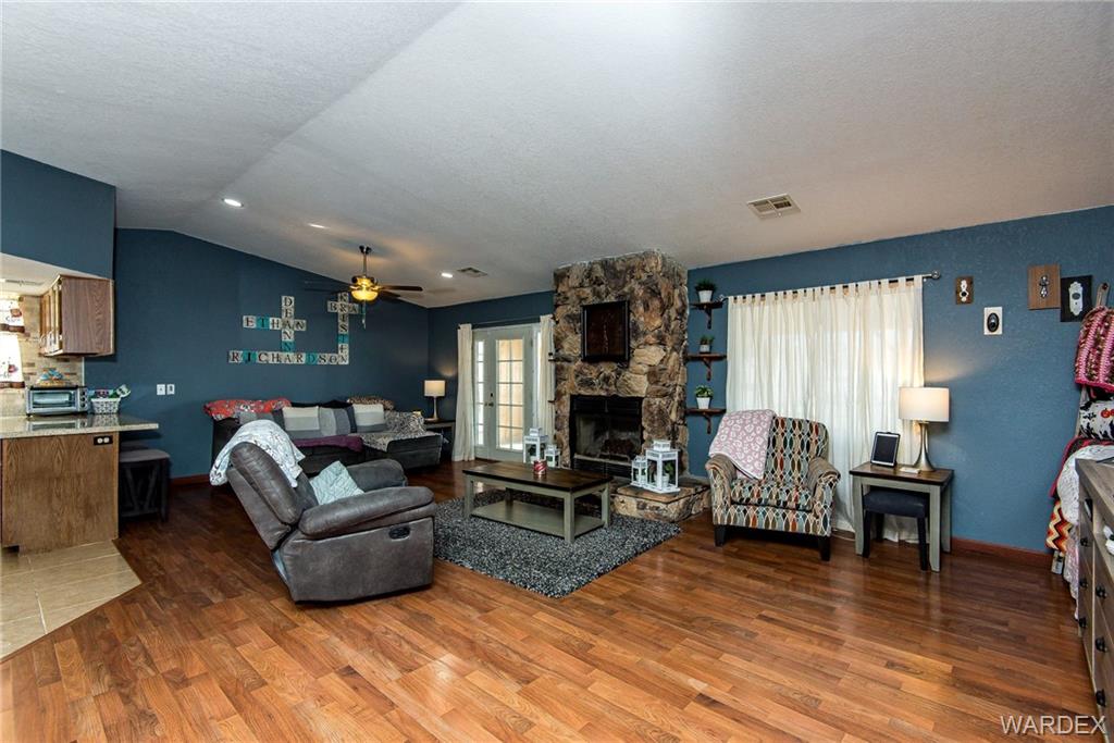 3925 Rising Sun Road Bullhead City, AZ 86442 - Photo 11 of 61 a living room with fireplace furniture and a wooden floor