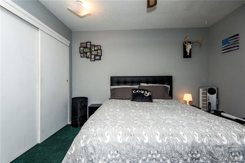 3925 Rising Sun Road Bullhead City, AZ 86442 - Photo 45 of 61 a bed sitting in a bedroom next to a window
