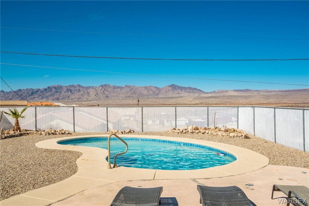 3925 Rising Sun Road Bullhead City, AZ 86442 - Photo 54 of 61 a view of a backyard with a table and chairs