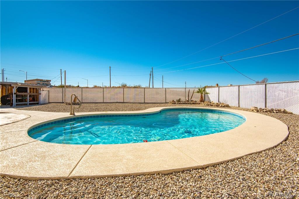 3925 Rising Sun Road Bullhead City, AZ 86442 - Photo 56 of 61 a view of a swimming pool with a yard