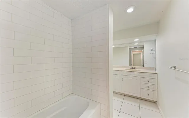 a bathroom with a granite countertop sink a toilet and mirror