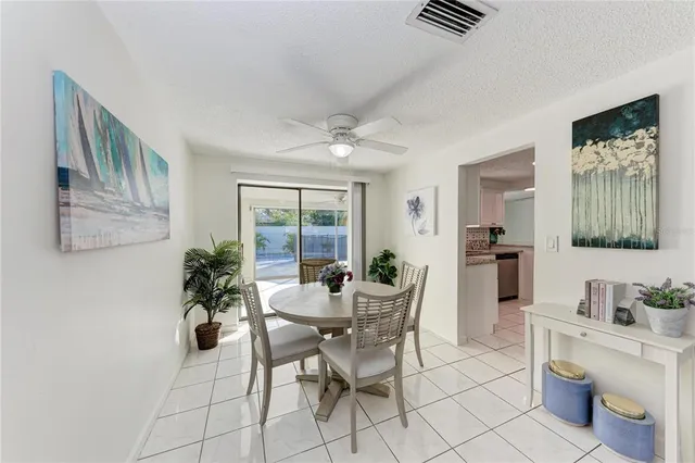 a view of a dining room with furniture and a potted plant