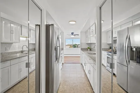 a kitchen that has a sink and a stove