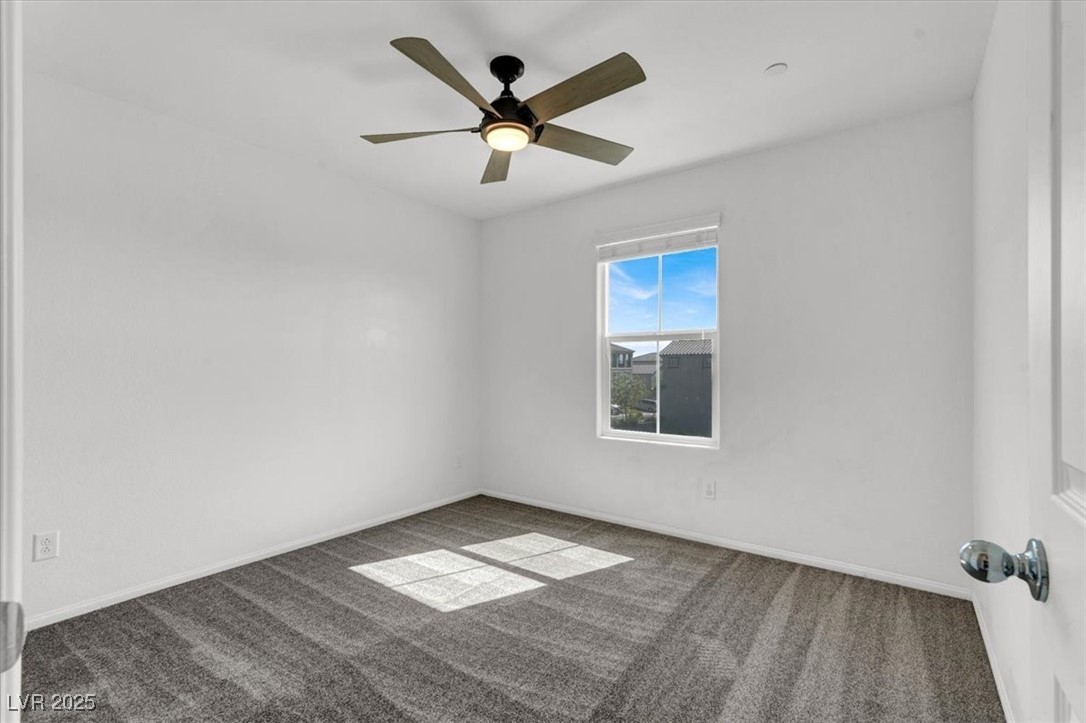8033 Skye Foxx Street Las Vegas, NV 89166 - Photo 13 of 25 Carpeted empty room featuring baseboards and ceiling fan