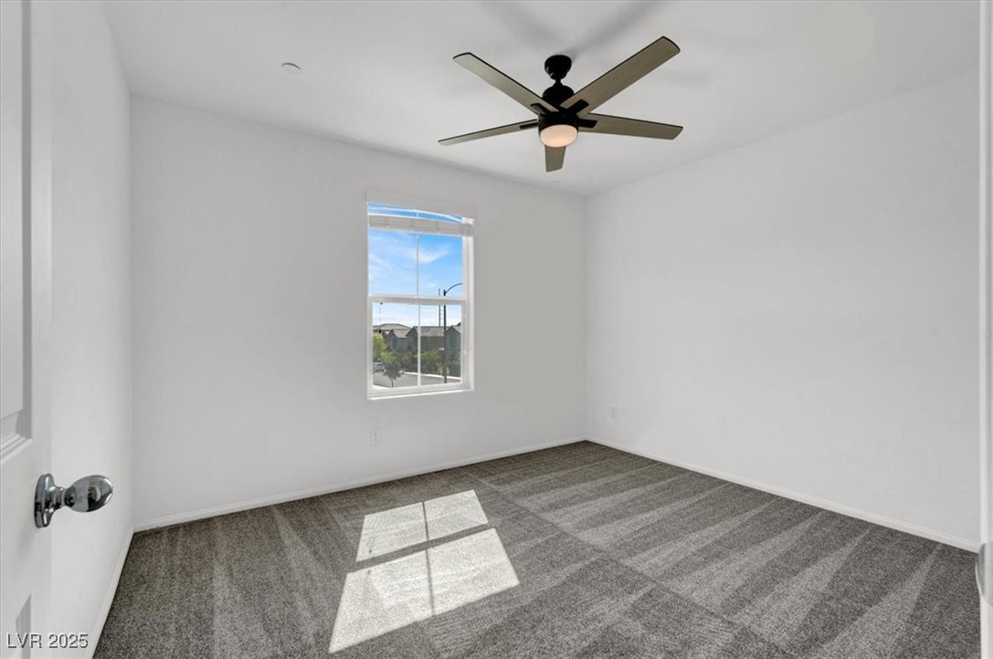 8033 Skye Foxx Street Las Vegas, NV 89166 - Photo 15 of 25 Carpeted spare room featuring a ceiling fan and baseboards