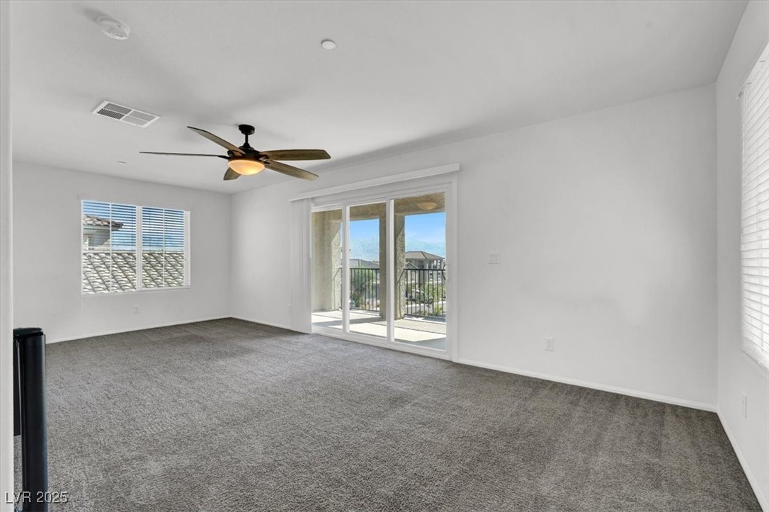 8033 Skye Foxx Street Las Vegas, NV 89166 - Photo 17 of 25 Carpeted empty room featuring a ceiling fan and baseboards