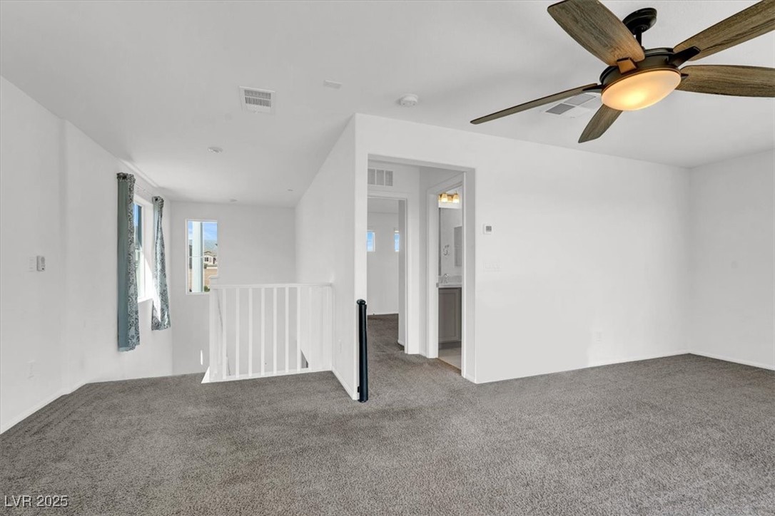 8033 Skye Foxx Street Las Vegas, NV 89166 - Photo 19 of 25 Empty room with carpet and ceiling fan