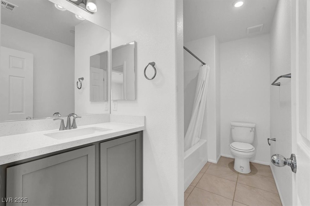 8033 Skye Foxx Street Las Vegas, NV 89166 - Photo 20 of 25 Bathroom featuring light tile patterned flooring, shower / bathtub combination with curtain, and vanity