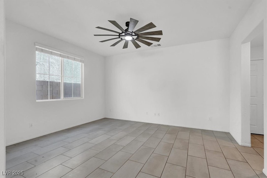 8033 Skye Foxx Street Las Vegas, NV 89166 - Photo 5 of 25 Empty room with ceiling fan