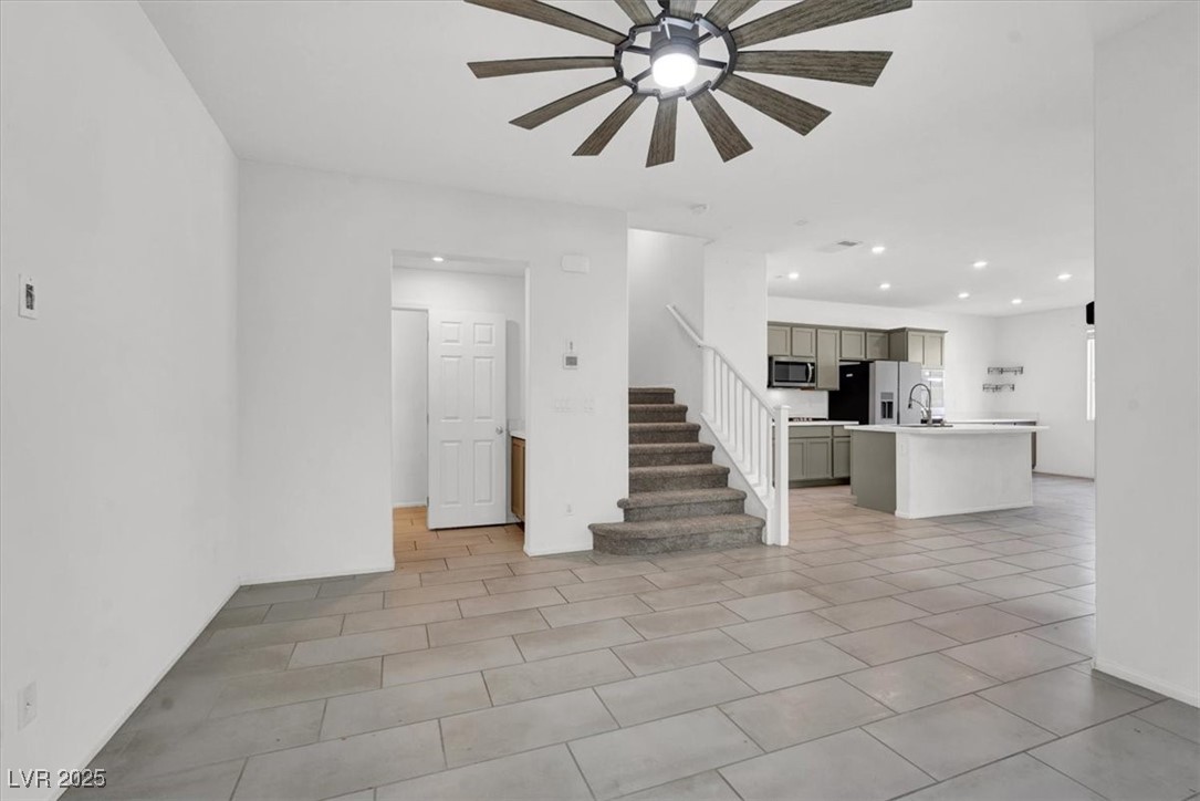 8033 Skye Foxx Street Las Vegas, NV 89166 - Photo 6 of 25 Unfurnished living room featuring stairs, recessed lighting, a ceiling fan, and light tile patterned flooring