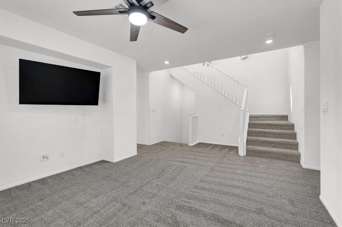 8033 Skye Foxx Street Las Vegas, NV 89166 - Photo 9 of 25 Unfurnished living room with carpet floors, stairway, ceiling fan, and recessed lighting