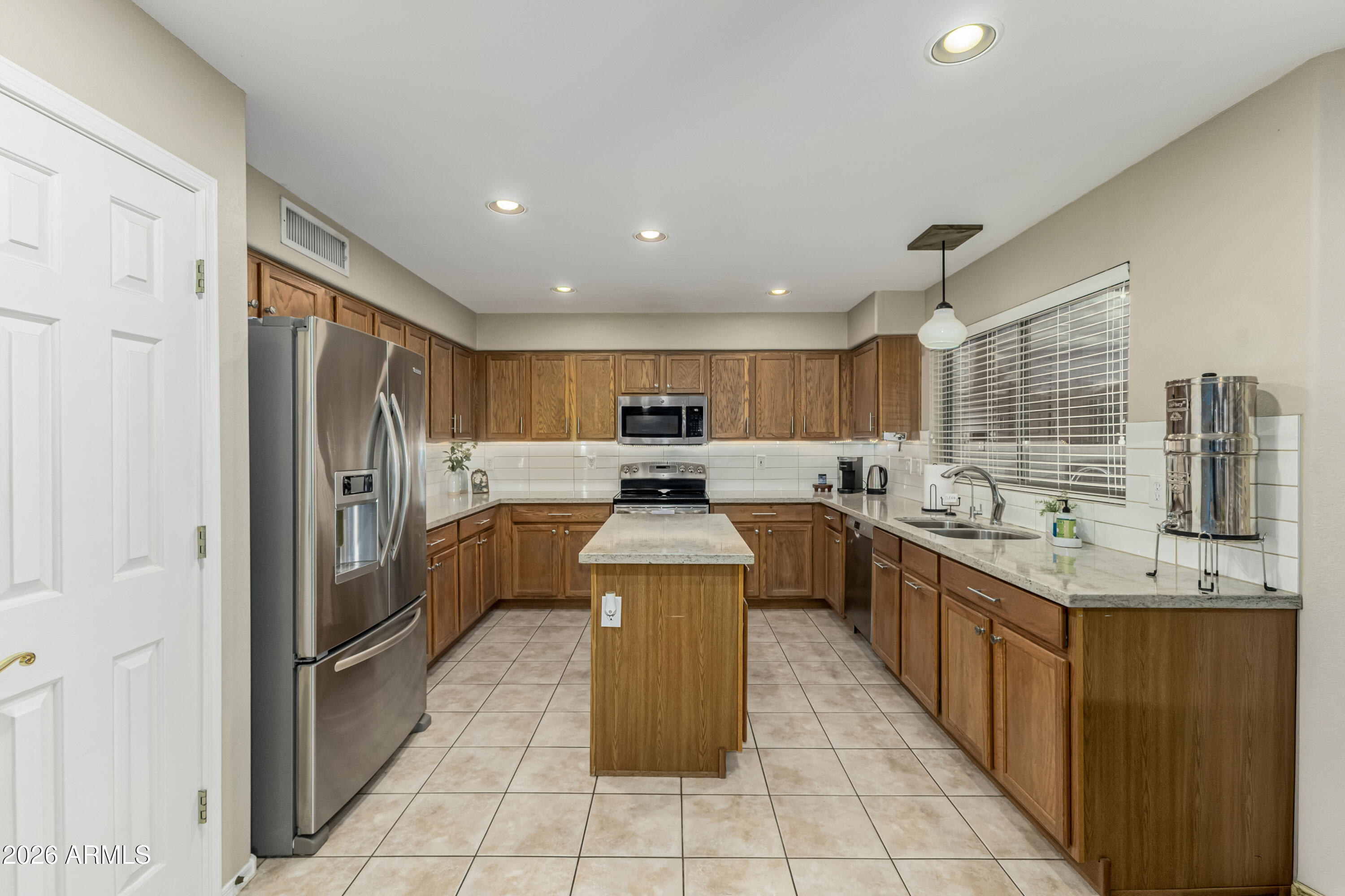1737 South Talbot Mesa, AZ 85209 - Photo 13 of 35 a kitchen with stainless steel appliances granite countertop a stove top oven a sink and a refrigerator