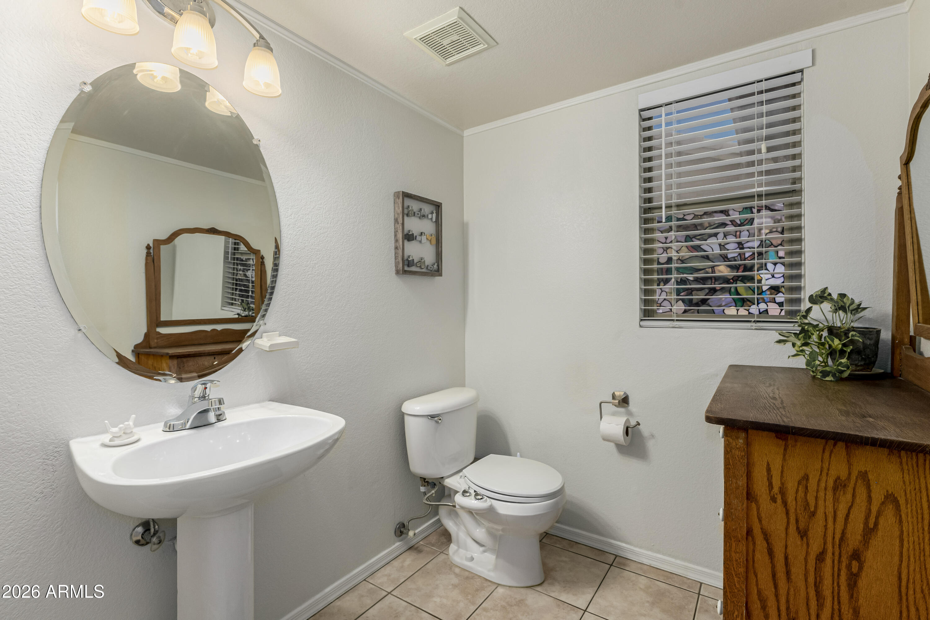 1737 South Talbot Mesa, AZ 85209 - Photo 16 of 35 a bathroom with a toilet a sink and a mirror