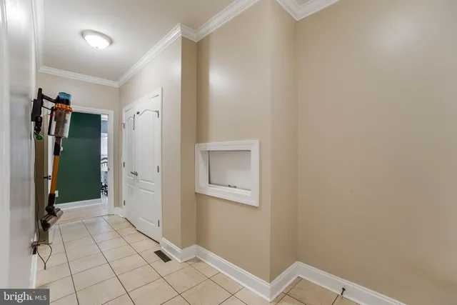 a view of staircase with wooden floor and white walls